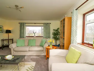 a living room with two couches and a table at Blaenywawr in Cross Inn