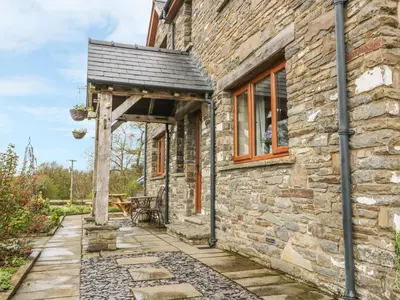 an entrance to a stone house with a wooden doorway at Blaen Henllan in Aberedw