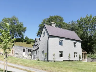a large white house with a gray roof at Lower Hodre in Bucknell