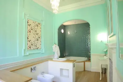 a bathroom with a tub and a toilet and a sink at Plas Nanteos Mansion in Aberystwyth
