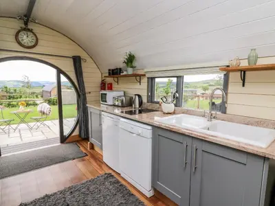 an eat in kitchen with a sink and a window at Mountain View in Saint Harmon