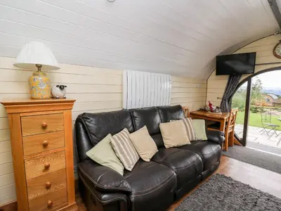 a leather couch in a living room with a window at Mountain View in Saint Harmon