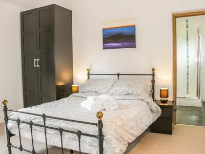 a bedroom with a bed with white towels on it at Acorn Cottage 2 in Petton