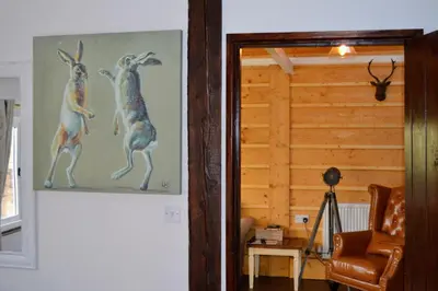 a doorway with a painting of two kangaroos at Arrowwood Self Catering (Wagtail and Nuthatch) in Kington