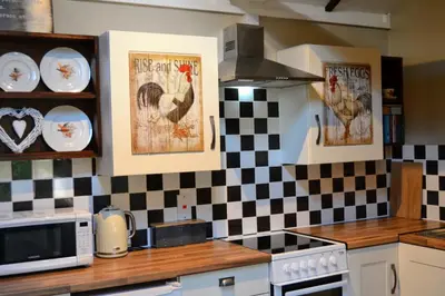 a kitchen with chickens posters on the wall at Arrowwood Self Catering (Wagtail and Nuthatch) in Kington