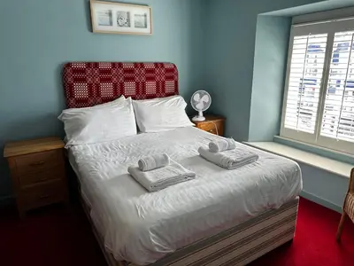 a bedroom with a bed with two towels on it at Castle Hotel in Aberaeron