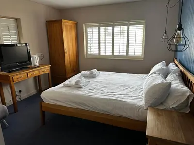a bedroom with a bed with two towels on it at Castle Hotel in Aberaeron