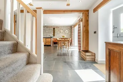 a kitchen and dining room with a staircase and a table at 3 Bed in Machynlleth oc-bow40 in Darowen