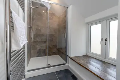 a walkin shower in a bathroom with a window at 3 Bed in Machynlleth oc-bow40 in Darowen