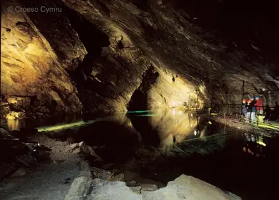 two people standing in a cave with a body of water at 3 Bed in Bala oc-bow26 in Llanuwchllyn