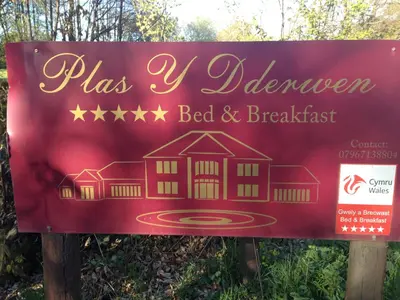 a sign for a bed and breakfast at Plas Y Dderwen Apartments in Aberystwyth