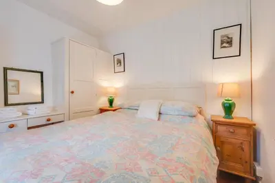 a bedroom with a large bed and two lamps at 3 Bed in Dolgellau oc-wah569 in Llanfachreth