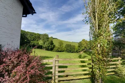a wooden fence in front of a green field at 2 Bed in Caersws oc-waa322 in Trefeglwys