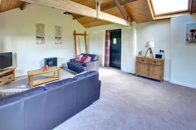 a living room with a blue couch and a tv at 1 Bed in Llandinam oc-waa376 in Llandinam