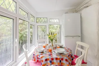 a dining room with a table and chairs and windows at 3 Bed in Bala oc-waf247 in Bettws Gwerfil Goch