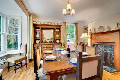a dining room with a table and a fireplace at 6 Bed in Dolgellau oc-wah675 in Arthog