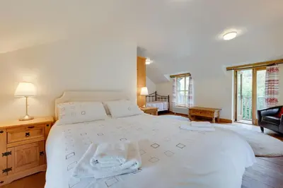 a bedroom with a large white bed with towels on it at 3 Bed in Dolgellau oc-wah570 in Llanfachreth