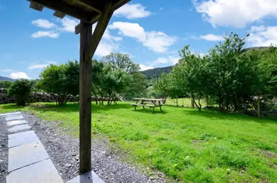 a picnic table in a field with trees and grass at 3 Bed in Dolgellau oc-wah570 in Llanfachreth