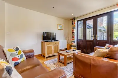 a living room with a couch and a tv at 4 Bed in Caersws oc-waa321 in Trefeglwys