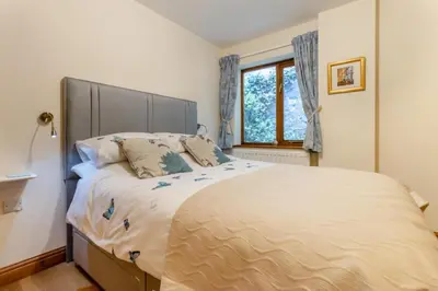 a bedroom with a large bed and a window at 4 Bed in Caersws oc-waa321 in Trefeglwys