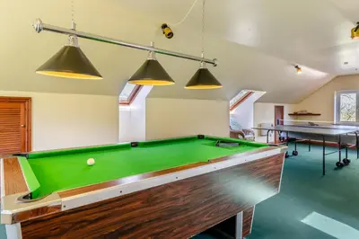 a billiard room with a pool table and two tables at 4 Bed in Caersws oc-waa321 in Trefeglwys