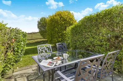 a glass table and chairs in a garden at 4 Bed in Caersws oc-waa321 in Trefeglwys