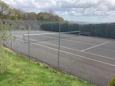 a tennis court with two tennis rackets on it at 4 Bed in Caersws oc-waa321 in Trefeglwys