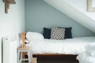 a bed with white sheets and pillows in a room at 3 Bed in Llangadfan oc-wae284 in Llangadfan