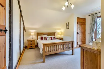 a bedroom with a bed and two tables and a window at 2 Bed in Caersws oc-waa345 in Trefeglwys