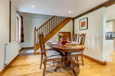 a dining room with a wooden table and chairs at 2 Bed in Caersws oc-waa345 in Trefeglwys