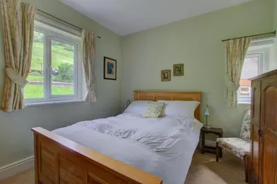 a bedroom with a large bed and a window at 3 Bed in Llangollen oc-waf216 in Glyn-Ceiriog