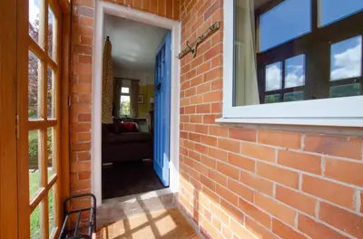 a brick wall with a door leading into a hallway at 3 Bed in Llangollen oc-waf216 in Glyn-Ceiriog