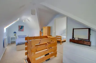 a bedroom with a bed and a dresser and a mirror at 3 Bed in Llangollen oc-waf216 in Glyn-Ceiriog