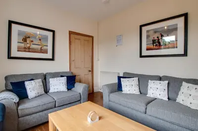 a living room with two couches and a coffee table at 4 Bed in Barmouth oc-wah585 in Penmaenpool