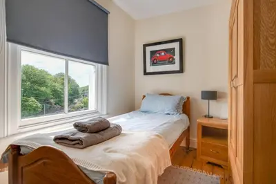 a bedroom with a bed and a window at 4 Bed in Barmouth oc-wah585 in Penmaenpool