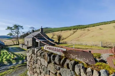 a stone wall in front of a building at 3 Bed in Dolgellau oc-wah605 in Rhydymain