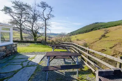 two picnic tables sitting on the side of a hill at 3 Bed in Dolgellau oc-wah605 in Rhydymain