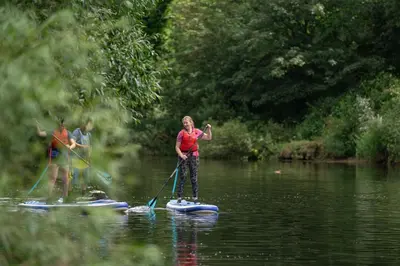 two people are on paddle boards in the water at 3 Bed in Dolgellau oc-wah605 in Rhydymain