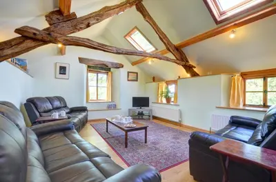 a living room with leather couches and a table at 4 Bed in Dolgellau oc-wah568 in Llanfachreth