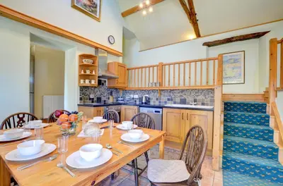 a dining room with a wooden table and chairs at 4 Bed in Dolgellau oc-wah568 in Llanfachreth