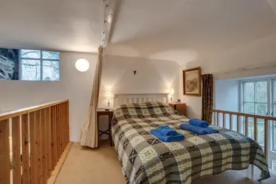 a bedroom with a bed with blue towels on it at 3 Bed in Dolgellau oc-wah484 in Llanfachreth
