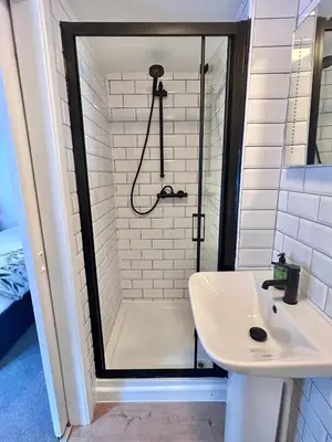 a bathroom with a shower and a sink at The Beacons Guest House in Brecon