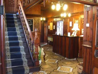 a room with a staircase in a house at Tyr Graig Castle in Barmouth