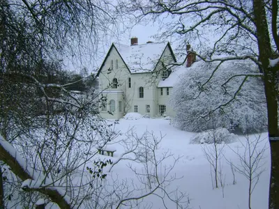 a large white house with snow on the ground at The Forest Country House B&B in Newtown