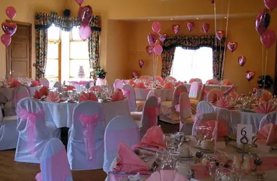 a room filled with tables and chairs with pink balloons at Burton Hotel in Kington
