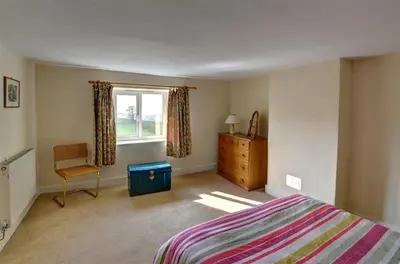 a bedroom with a bed and a window and a chair at 4 Bed in Presteigne oc-wak235 in Norton