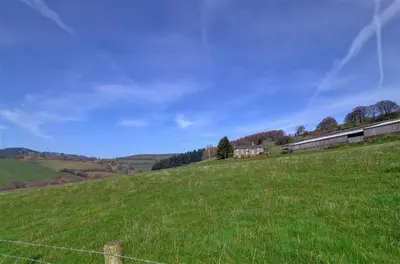 a green field with a fence on a hill at 4 Bed in Presteigne oc-wak235 in Norton