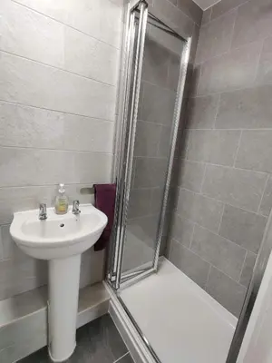 a bathroom with a shower and a sink at Llwynygog Guest House in Aberystwyth