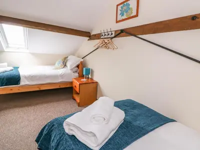 a bedroom with two beds and a window at Pentre Fach in Llanddewi Ystradenny