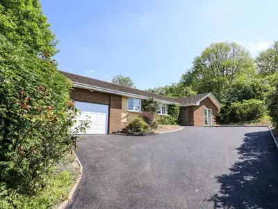 a house with a driveway and a garage at Pen Y Maes in Builth Wells